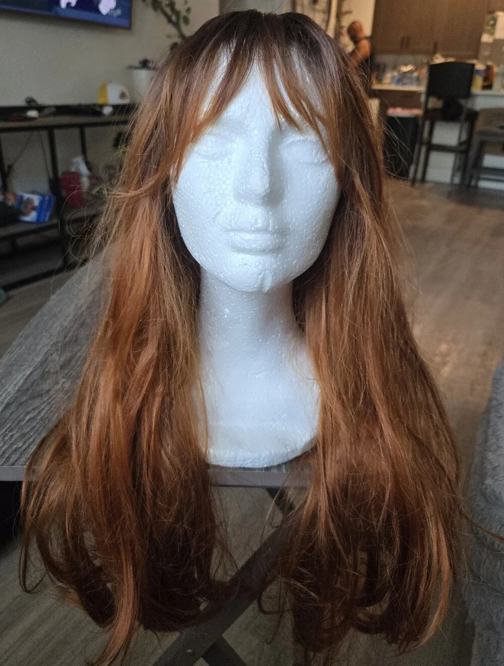 long auburn wig with dark brown roots and face-framing wispy bangs Sunthetic